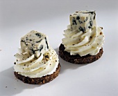 Pumpernickel rounds topped with soft cheese & blue cheese