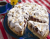 Cherry cake with meringue and flaked almonds