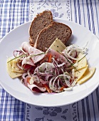 Hearty sausage salad with cheese and bread