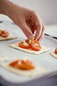 Putting tomatoes on puff pastry