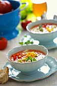 Gazpacho with diced vegetables in two soup cups