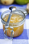 Pear jam in jar with spoon