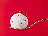 A scoop of chilli ice cream on a spoon