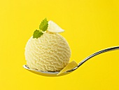 A scoop of lemon ice cream on a spoon