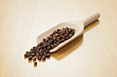 Red peppercorns in wooden scoop