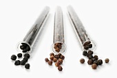 Various types of peppercorns in glass tubes