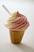 Strawberry and vanilla soft ice cream in cone