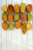 Prickly pears on white painted wooden background