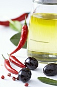 Olive oil, chillies, black olives and peppercorns