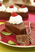 Chocolate mousse cake with cream and raspberries