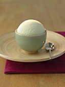 A scoop of tea ice cream in a small green bowl