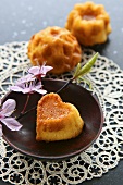 Small heart-shaped sponge cake with sprig of cherry blossom