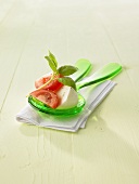 Tomatoes with mozzarella and basil on salad servers