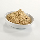 A heap of organic brown millet (gluten-free) in dish
