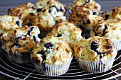 Freshly baked blueberry muffins on cake rack