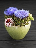 Artichoke flowers in bowl of flowers