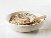 Pearl barley in bowl with wooden scoop