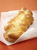 Bread plait on greaseproof paper