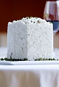 Cube of salt with green peppercorns