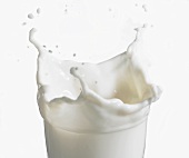 Milk splashing out of a glass