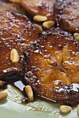 Caramelised apple slices with pine nuts