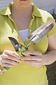 Woman holding garden tools