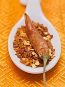 Chilli flakes and dried chilli on spoon