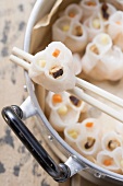 Dim sum in pan and on chopsticks (China)