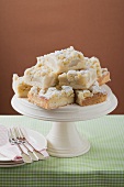 Several pieces of pear crumble cake on cake stand