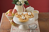 Pear tartlets with cream on cake stand