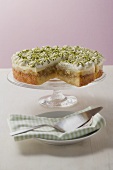 Apple cake with cream and pistachios, a piece cut