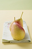 Two Forelle pears on a tea towel