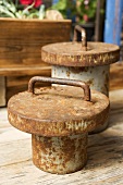 Old, rusty weights on wooden table (close-up)