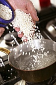 Pouring rice into boiling water