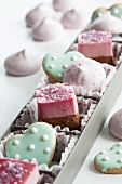 Raspberry petit fours, heart-shaped biscuits and raspberry meringues in a box