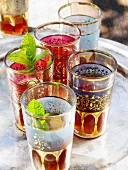 Five oriental tea glasses on a tray