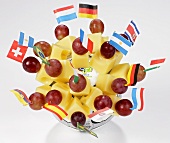 Cheese on cocktail sticks with various flags on football