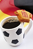 Coffee in mug with football motif