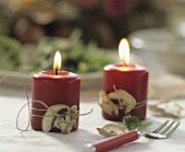 Candles with dried mushrooms tied on with string