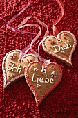 Gingerbread hearts with writing against red background