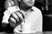Man stirring espresso (black and white photo)