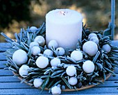 Olive wreath with white baubles and candle