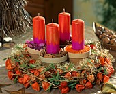 Physalis Advent wreath and terracotta pots with spices 