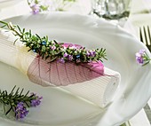 Napkin decoration with sprig of rosemary