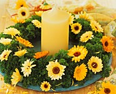 Wreath of parsley with marigolds and a candle