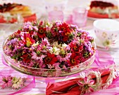 Wreath of love-in-a-mist and dahlias on glass tiered stand