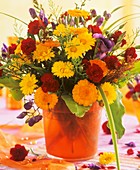 Arrangement of marigolds, pinks, monkshood & lisianthus