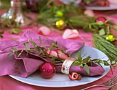 Place-setting with Eucalyptus, rose petals and tree baubles