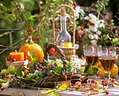 Autumn decoration: basket of vines, leaves, candles, wineglasses