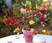 Arrangement of roses and rose hips